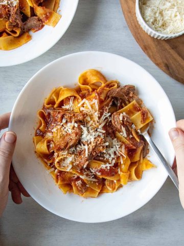 Slow Cooker Beef Ragu in a white bowl with a fork