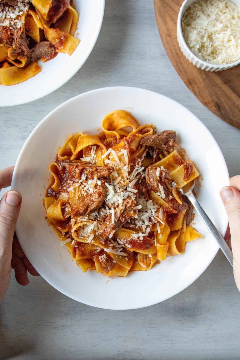 Slow Cooker Beef Ragu in a white bowl with a fork