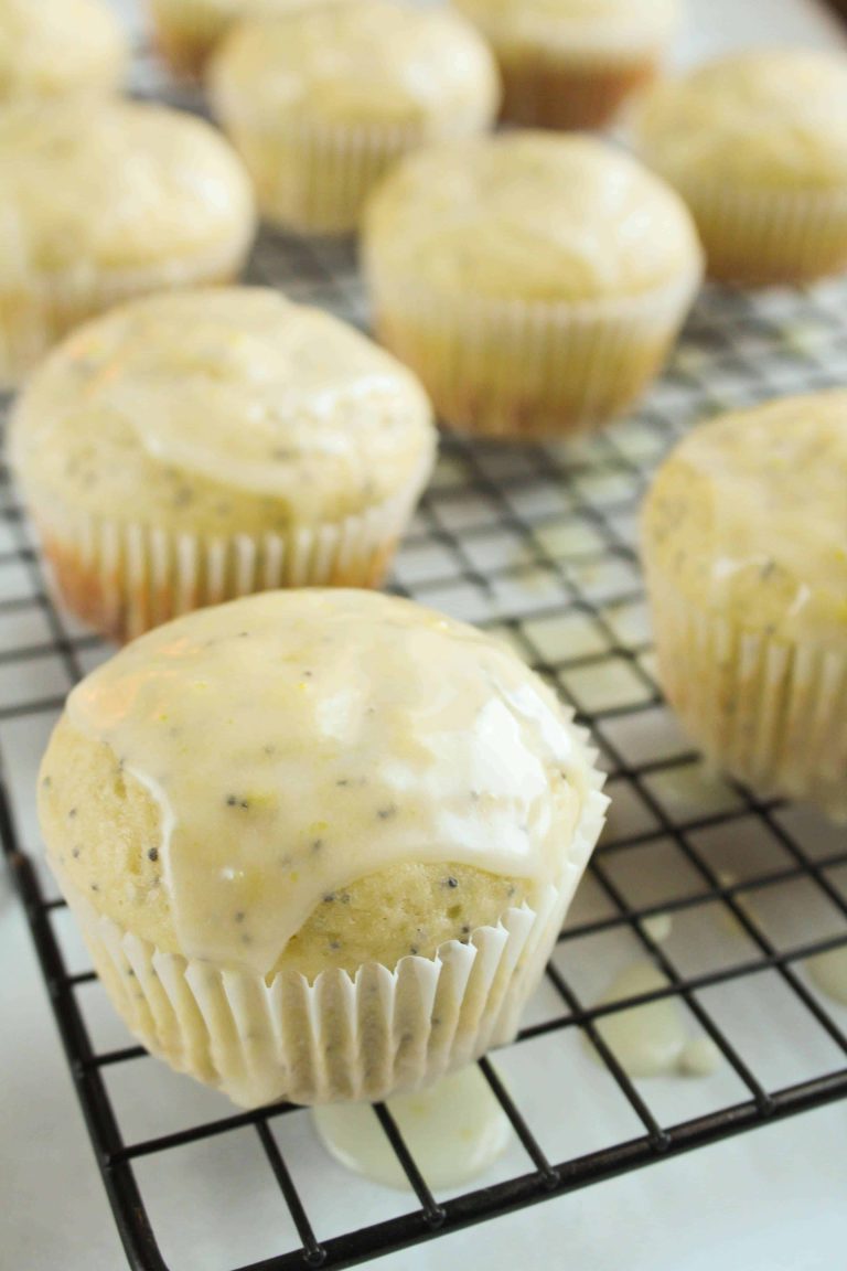 Extra Lemony Poppy Seed Muffins on a cooling rack.