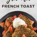 Granola French Toast on topped with strawberies and whipped cream- black pate