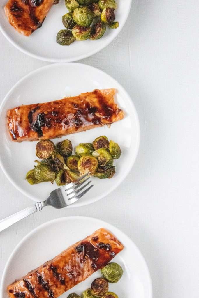 Honey Garlic Glazed Salmon with Roasted Brussel Sprouts on a white plate