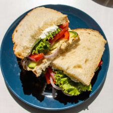 Mediterranean Veggie Sandwich with Whipped Feta on a blue plate