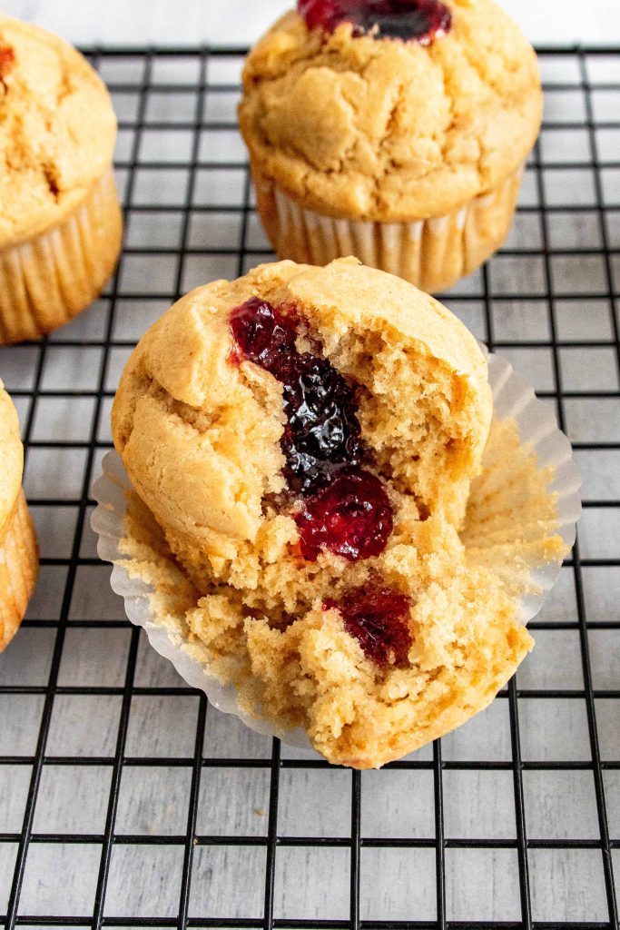 Peanut butter and Jelly Muffins on a black cooling rack