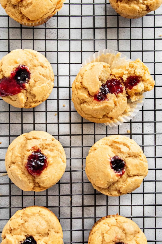 Peanut butter and Jelly Muffins on a black cooling rack