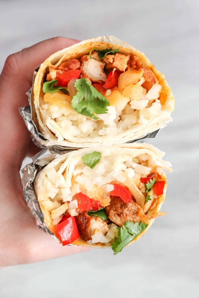 Chicken Burrito with Cauliflower Rice cut in half stacked on top of each other