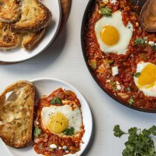 Shakshuka in a pan with bread