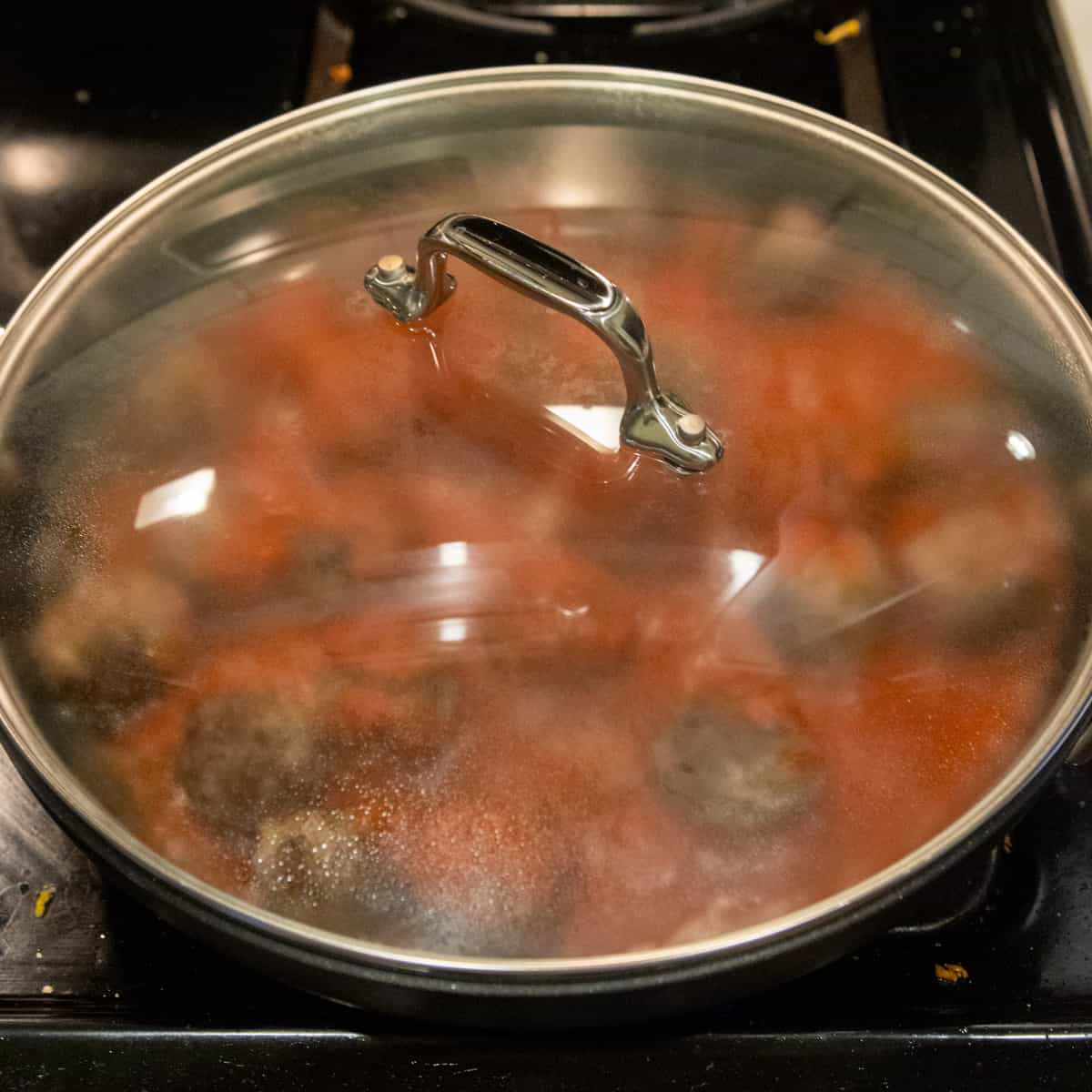 Meatballs cooking in pan With Lid