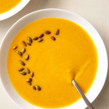 Squash Soup with toasted pepitas on top.