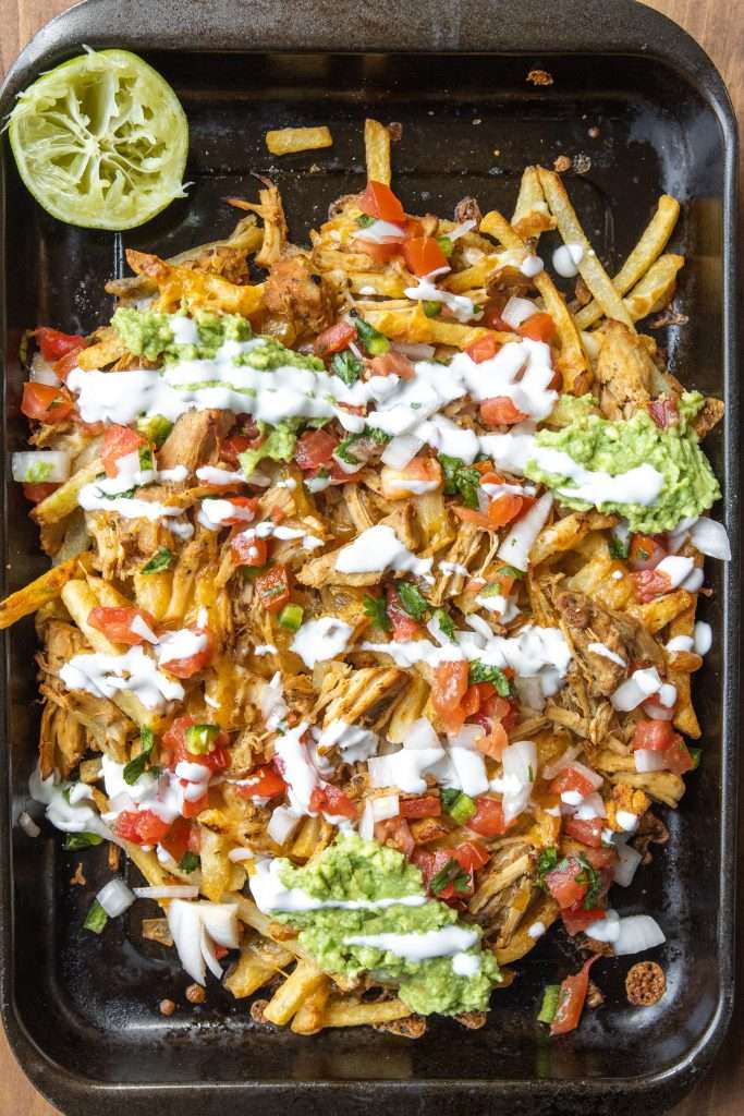 Carnitas fries on a sheet pan. 