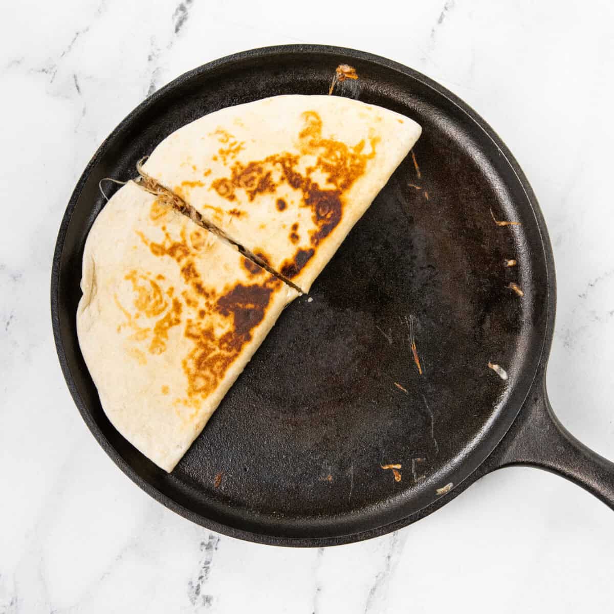 toasting Pulled Pork Carnitas Quesadilla on skillet