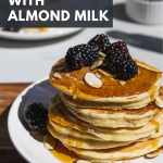 Almond Milk Pancakes topped with blackberries and almonds on a plate.