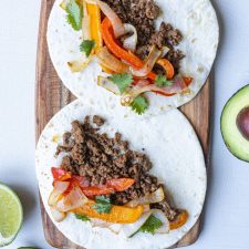 Ground Beef Tacos with Vegetables on a wooden serving tray.