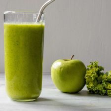 Apple Kale Smoothie with kale and an apple in the background