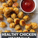 Healthy Baked Chicken Meatballs on a sheet pan with ketchup
