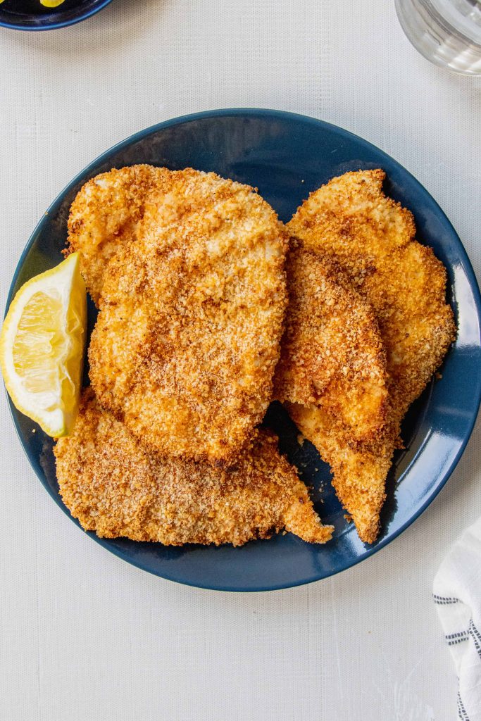 chicken cutlets on a blue plate 