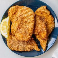 chicken cutlets on a blue plate