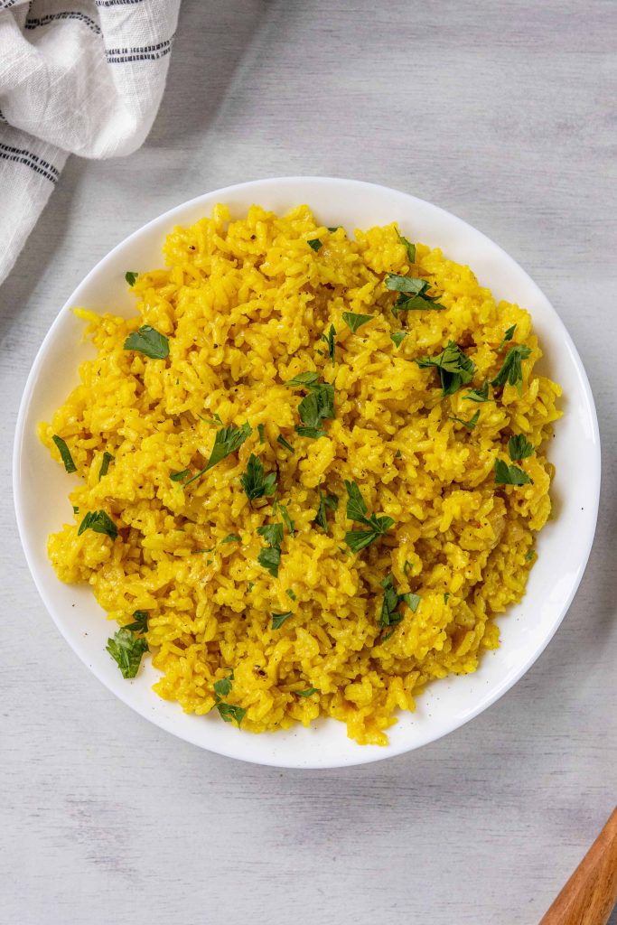 Yellow Mediterranean Rice in a bowl topped with green cilantro.