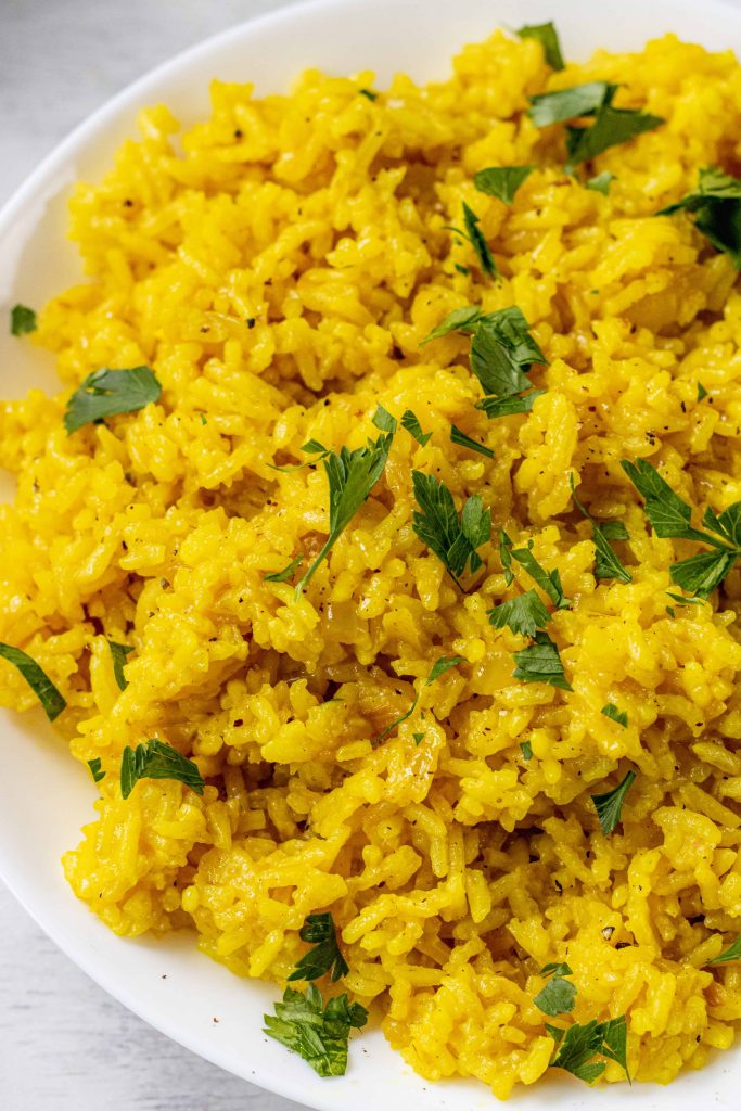 Yellow Mediterranean Rice in a bowl topped with green cilantro.