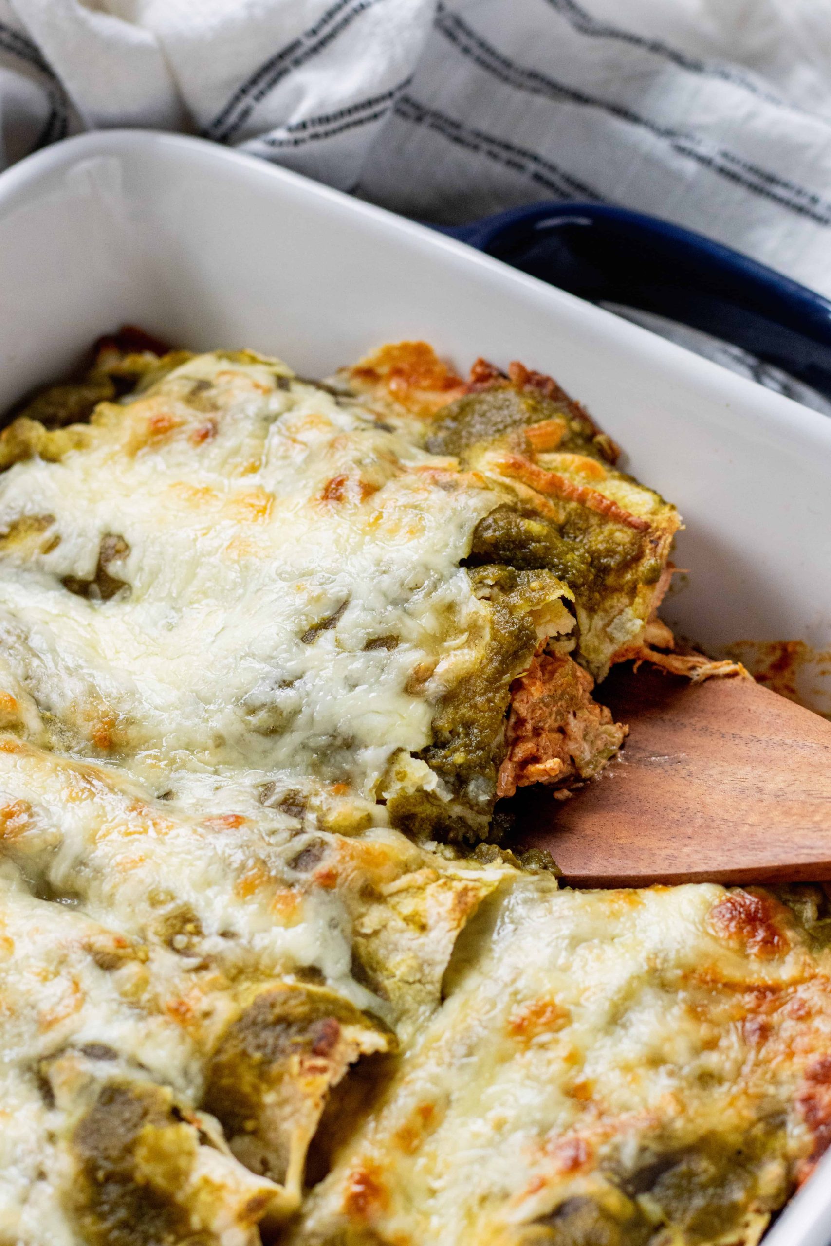 Green Chicken Enchiladas getting picked up by a spatula