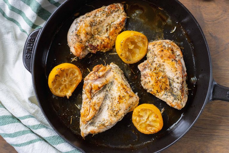 chicken in cast iron skillet with lemons