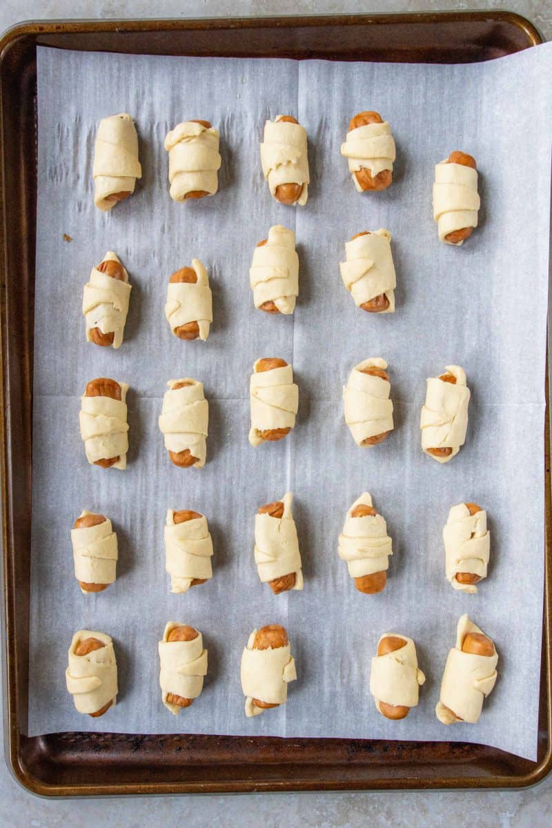 raw pigs in a blanket on a sheet pan