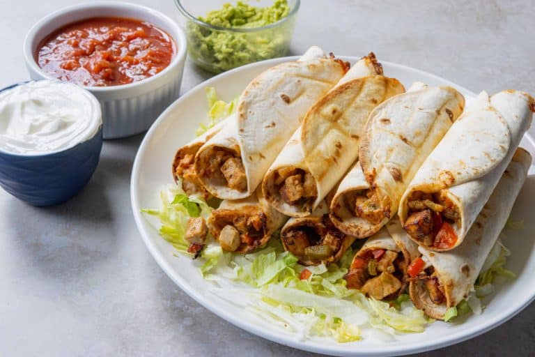 Air Fryer chicken Flautas on a bed of lettuce