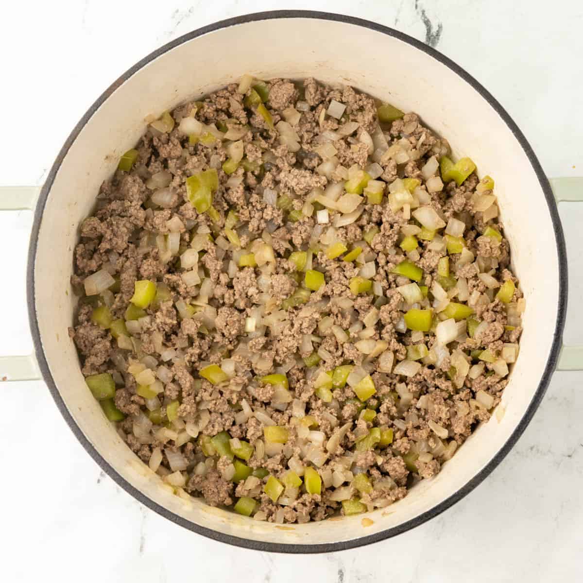 Cooking beef, bell pepper, and onion in a pot