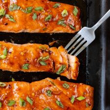Salmon on a sheet pan with a fork