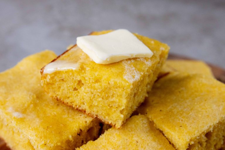 a pile of cornbread with butter on top
