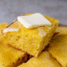 a pile of cornbread with butter on top