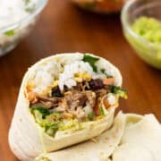 carnitas burritos finished with filling in the background