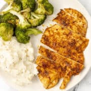 air fryer thin chicken breast on a plate with broccoli and mashed potatoes