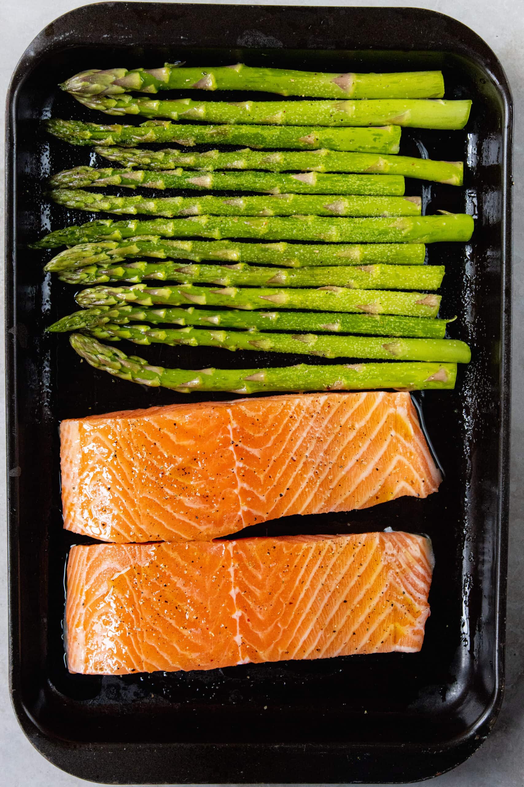 Raw Salmon on a pan with asparagus