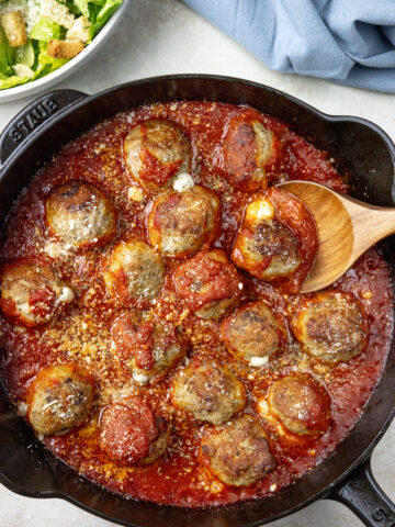Turkey Meatballs in a cast iron skillet with a spoon