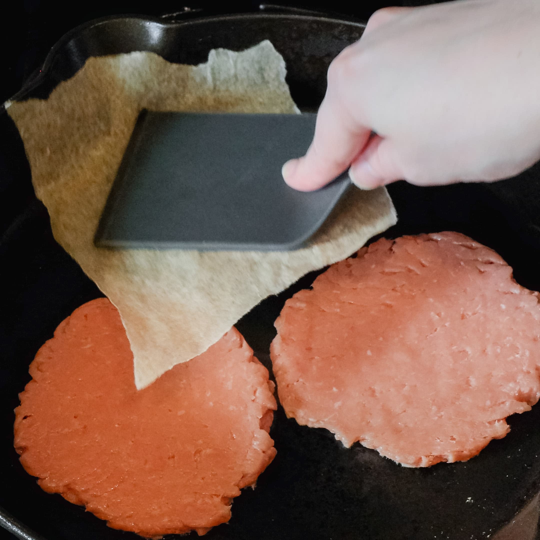 smashing turkey burger with spatula