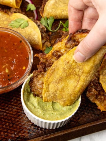 Crispy Beef Tacos Dipped into guacamole