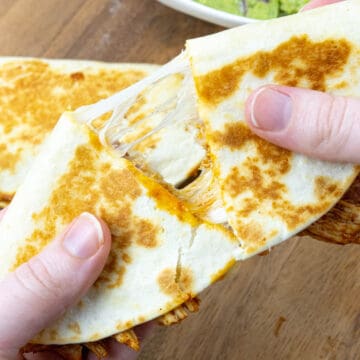 chicken quesadilla being pulled apart