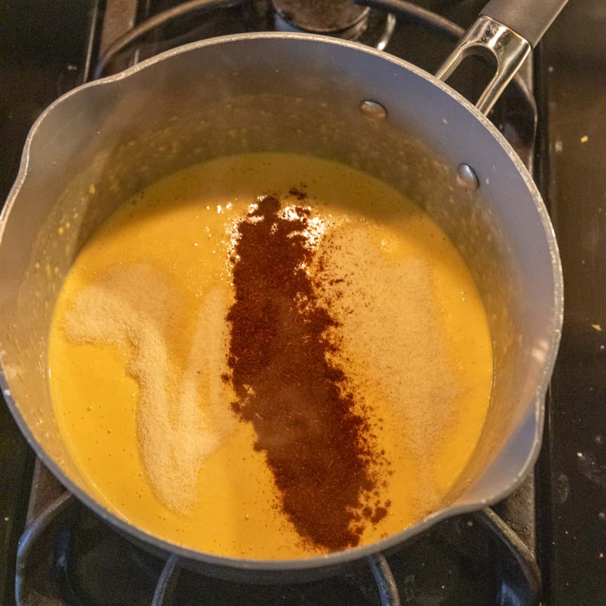 adding spices to the queso