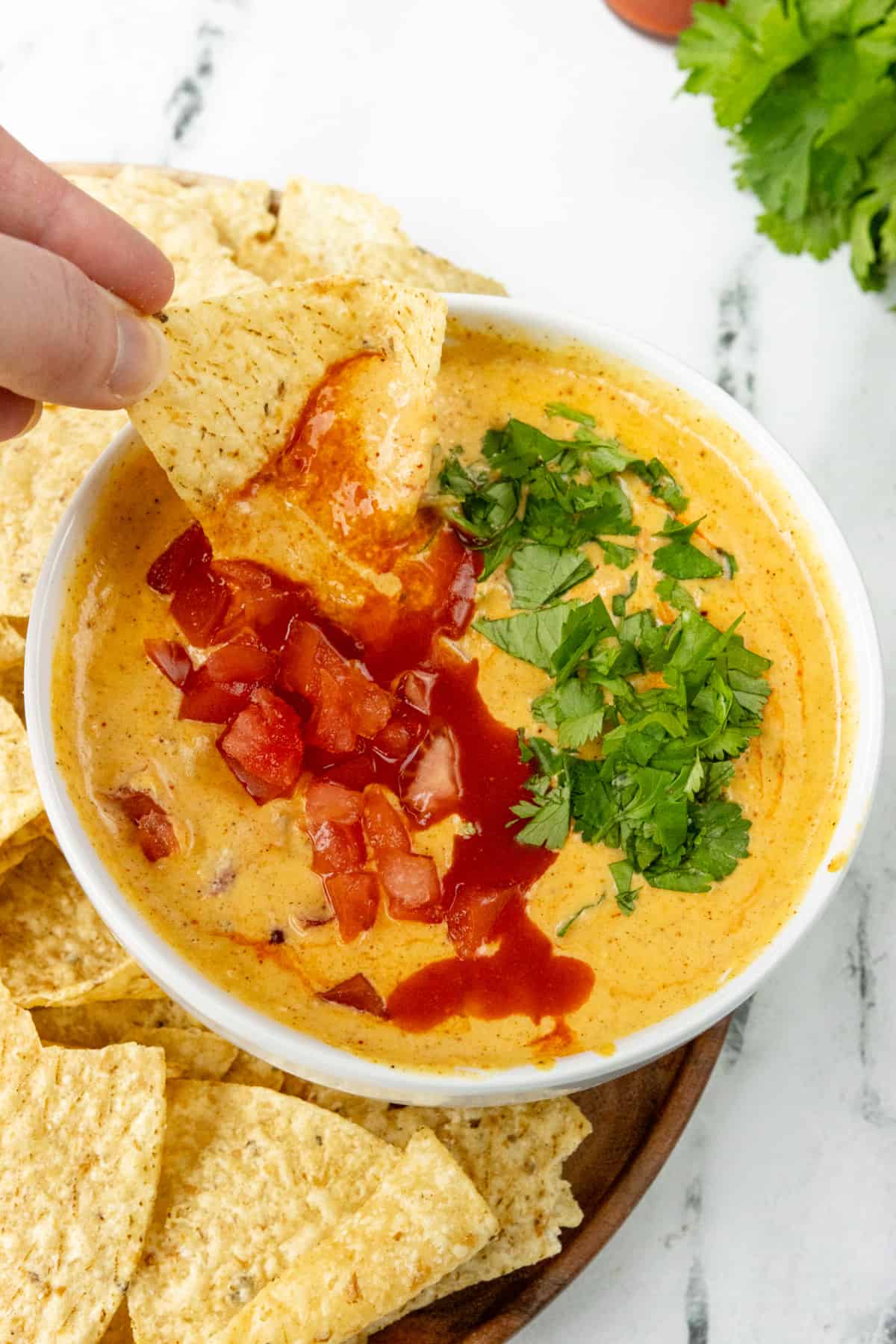 Dipping chip in queso