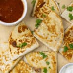 Cheese Quesadillas next to salsa and sour cream