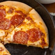 Cast Iron Pizza sliced on skillet