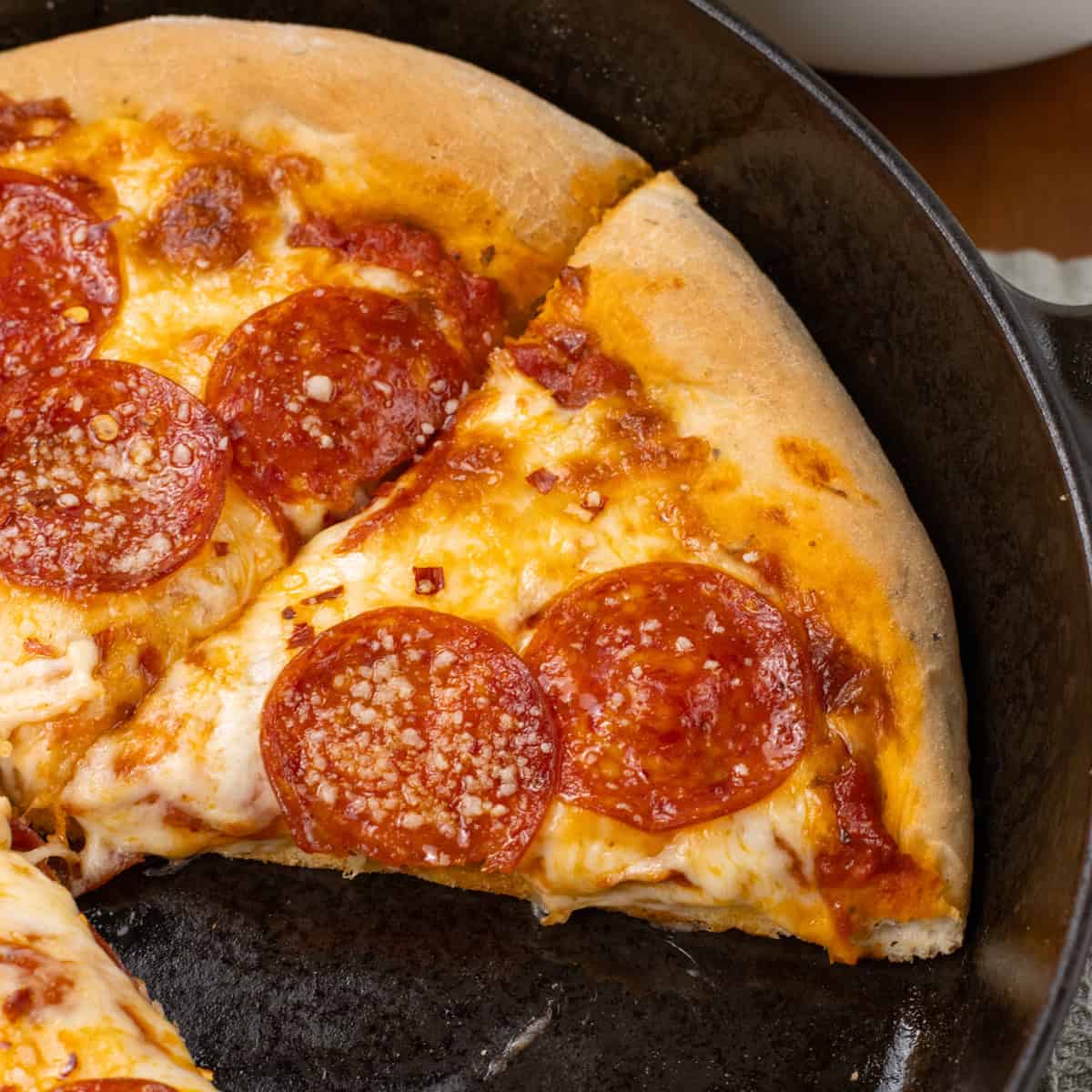 Cast Iron Pizza sliced on skillet