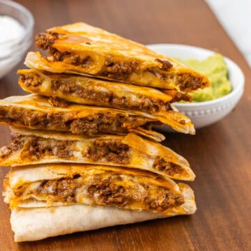 ground beef quesadillas served with guacamole and sour cream