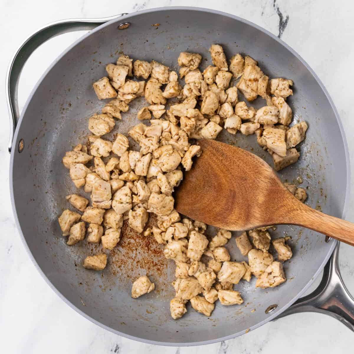 Chicken Pesto Flatbread Pizza chicken cooking on stove