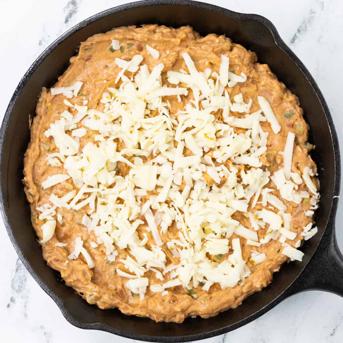 Spicy Refried Bean Dip ready to be cooked