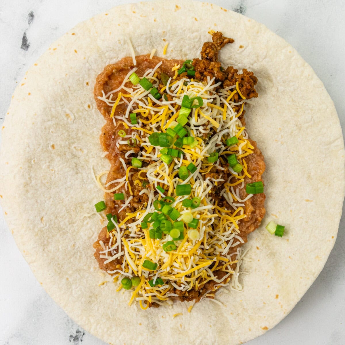 refried beans, cheese, jalapeños smeared on tortilla