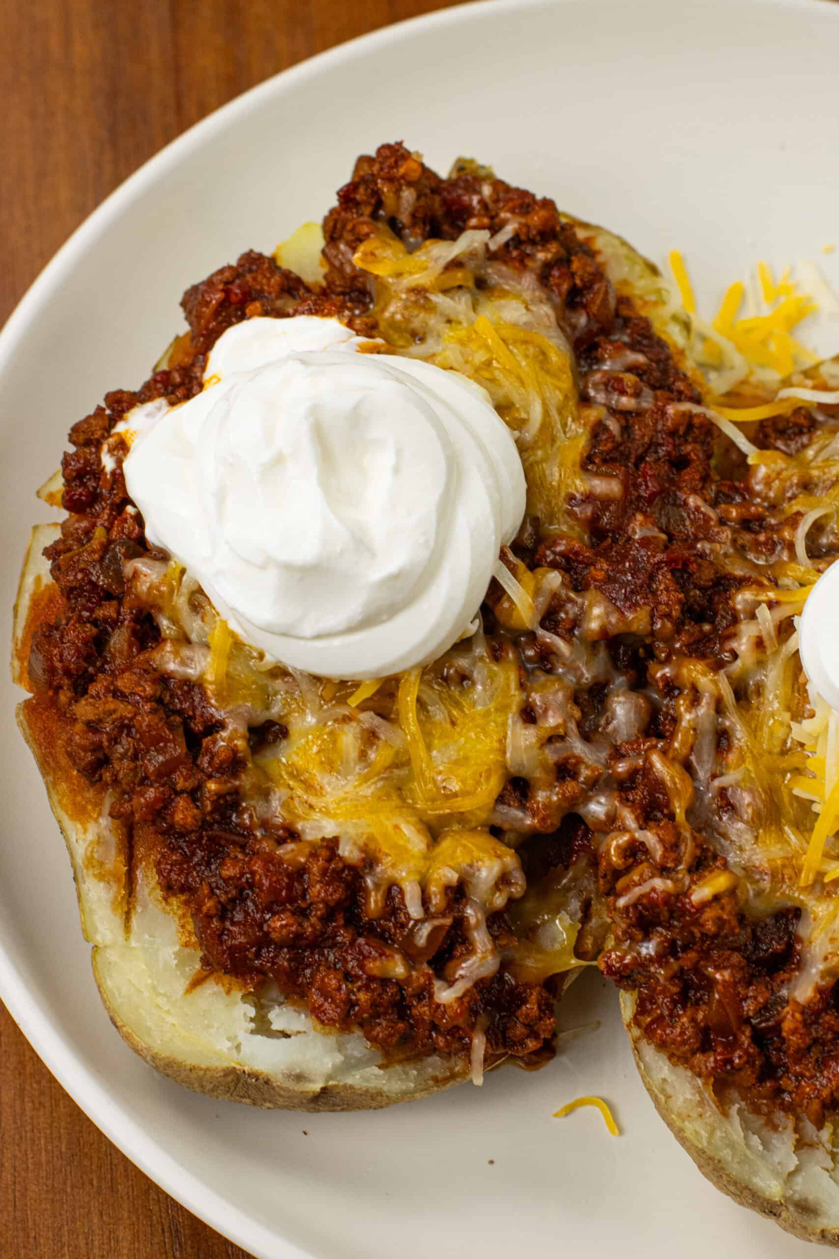 chili con carne on a potato with cheese and sour cream