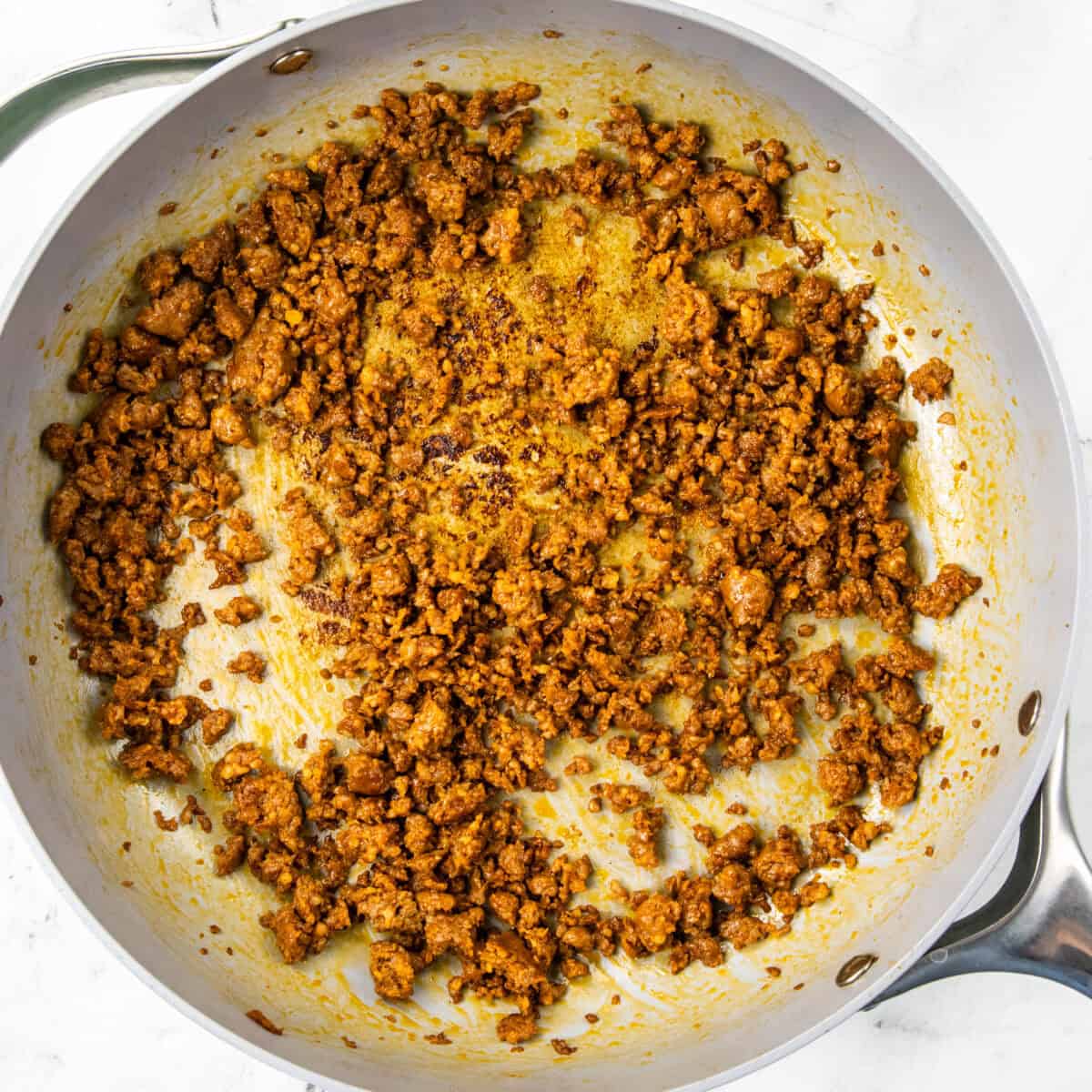 cooking chorizo in a pan for Chorizo Potato Egg and Cheese Breakfast Tacos
