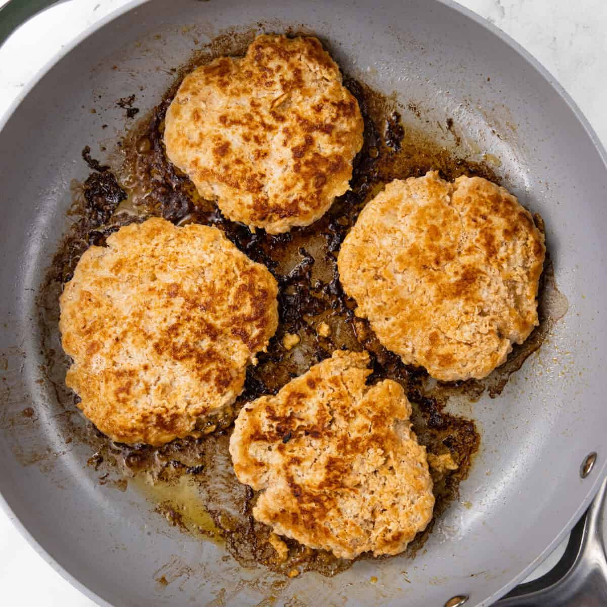 cooking patties for Buffalo Ground Chicken Burger with Whipped Goat Cheese