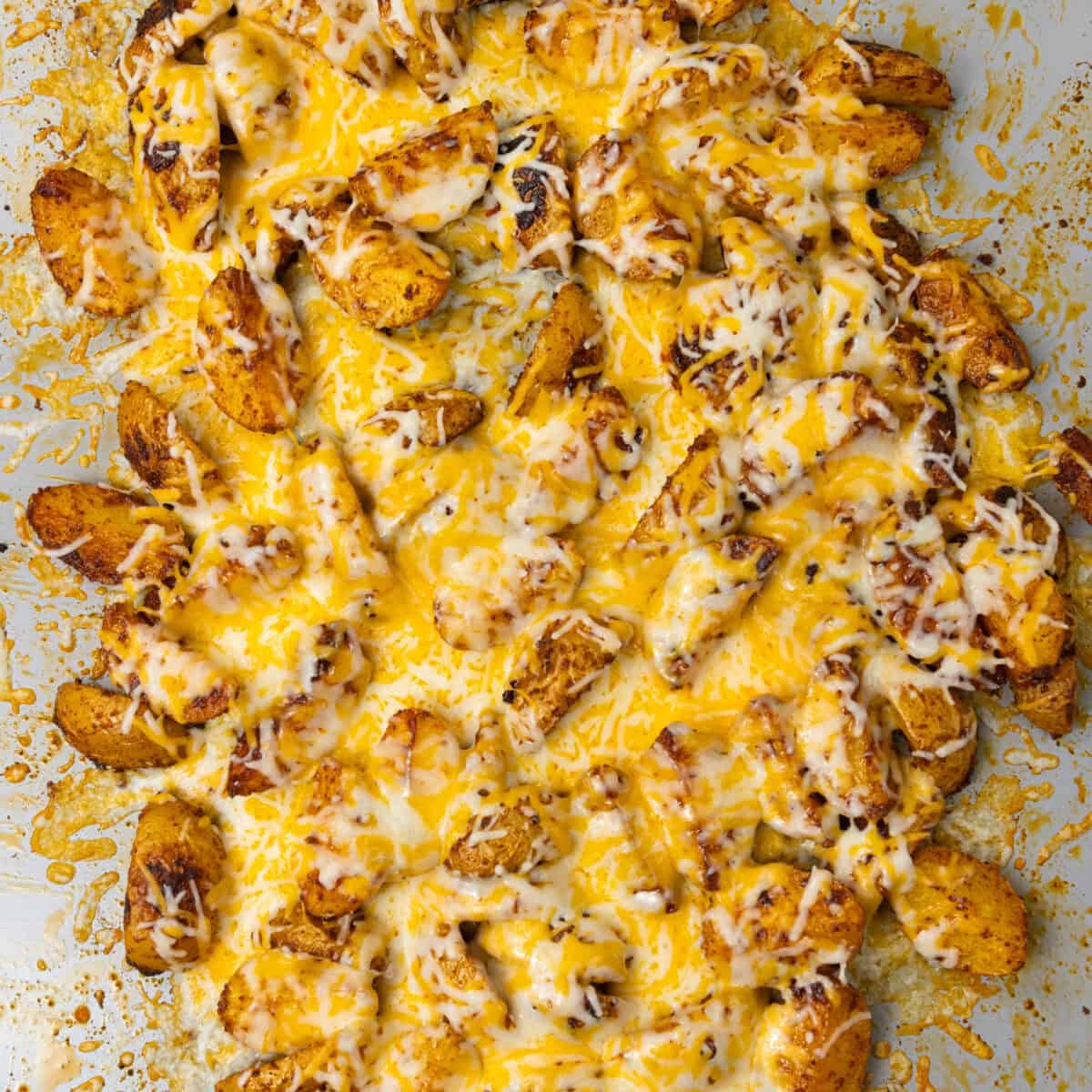 Melting cheese over baked potatoes for Fiesta Potato Taco Bowl
